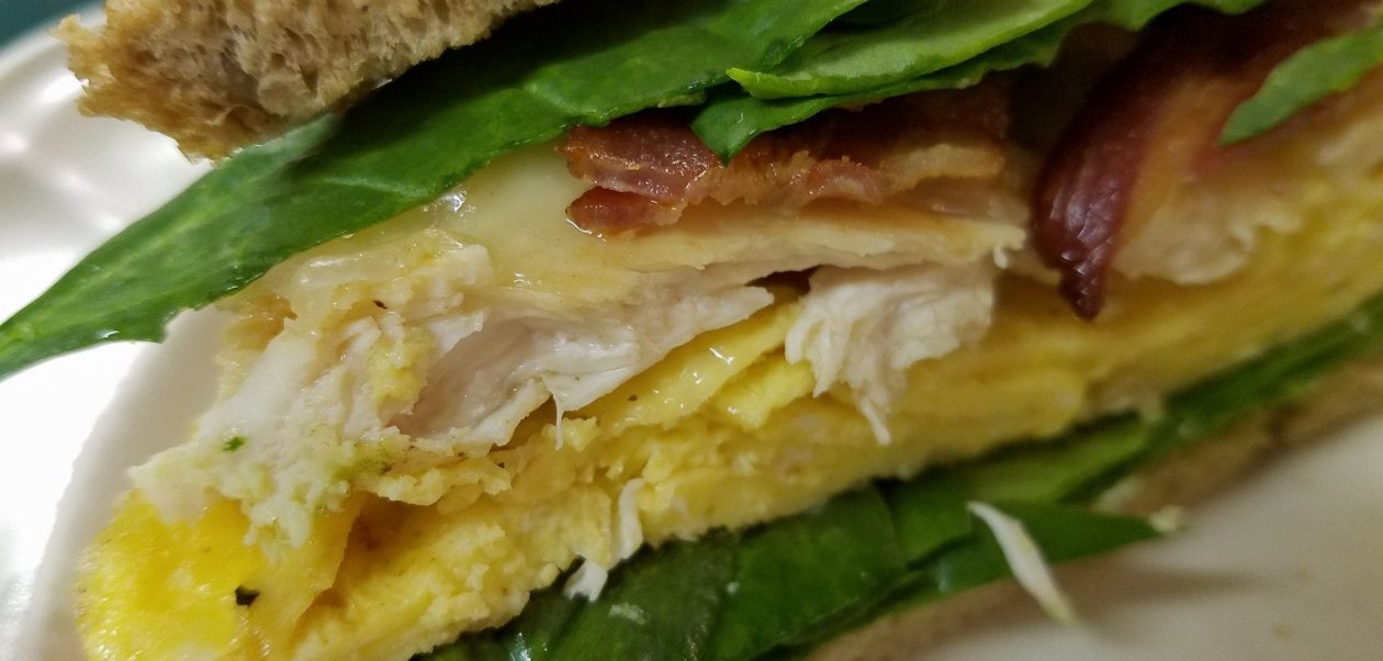 chicken spinach bacon swiss egg sandwich on toast